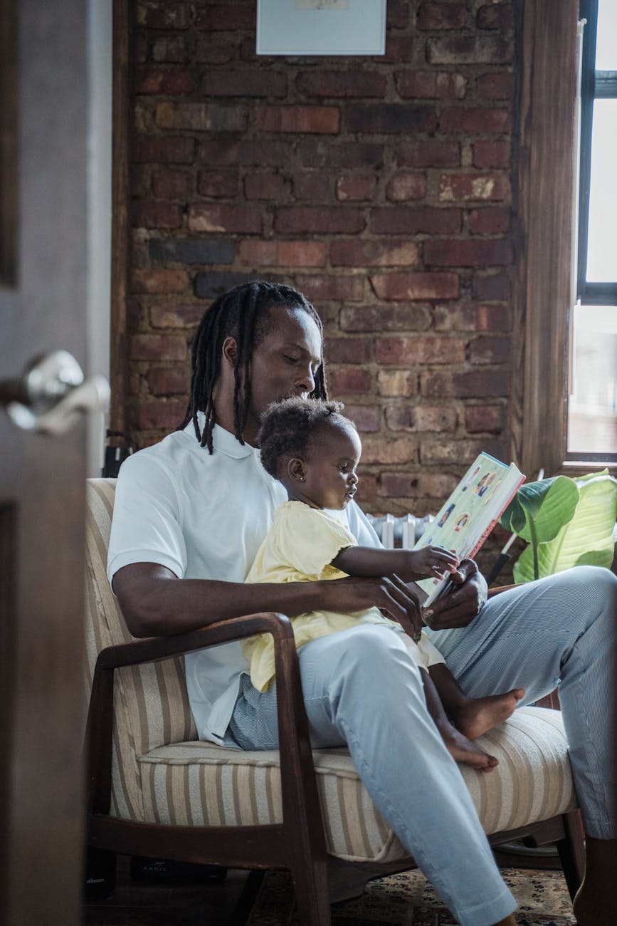 a father reading a book to his child
